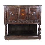 A 17th century and later oak side cupboard, the top over two cupboard doors flanking a marquetry