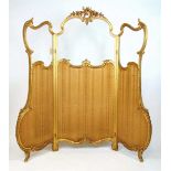 A 19th century French giltwood Rococo style three fold screen, the glazed panels over striped fabric
