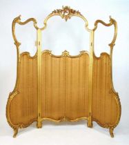 A 19th century French giltwood Rococo style three fold screen, the glazed panels over striped fabric