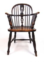 An early 19th century elm and beech Windsor chair, the spindle back over a shaped seat on turned