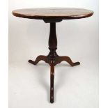 An 18thh century elm tripod table, the circular top on a turned column and three sweeping legs, h.