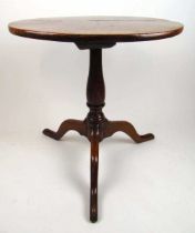 An 18thh century elm tripod table, the circular top on a turned column and three sweeping legs, h.
