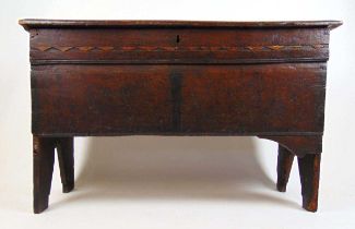 A late 17th century oak coffer, the top lifting to reveal a vacant interior over a bog oak and holly