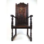 A 19th century oak and beech Wainscot chair, the carved back over the solid seat on turned front