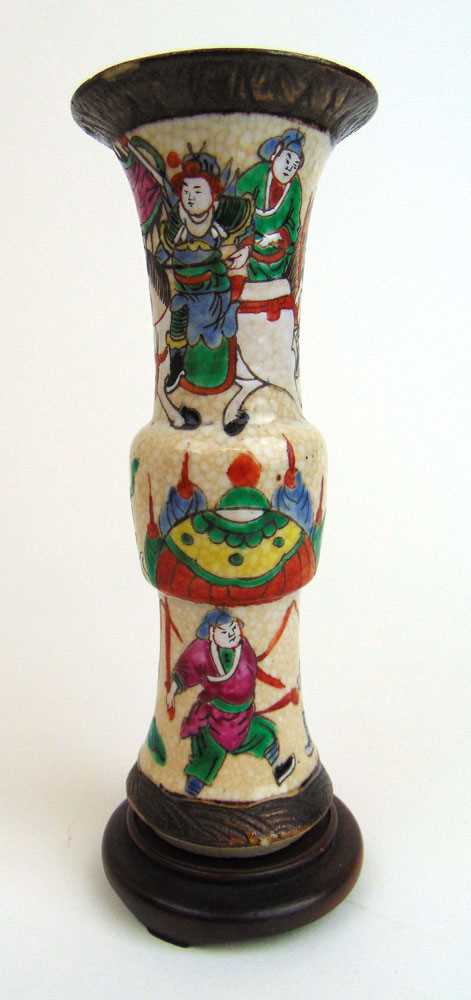 An early 20th century Chinese Gu shaped vase decorated with warriors and horses on wooden base, h.