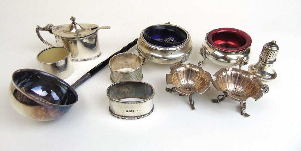 A collection of silver and white metal items to include toddy ladle, open salts, mustard pot etc.