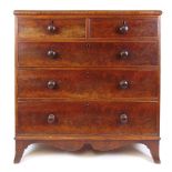 A 19th century mahogany chest of two short over three graduated drawers on splay feet flanking a