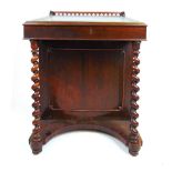 A 19th century rosewood Davenport, the quatrefoil pierced galleried top over the slope with tooled
