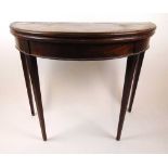 A late 18th century mahogany demi lune tea table, the fold over top supported on a twin gate