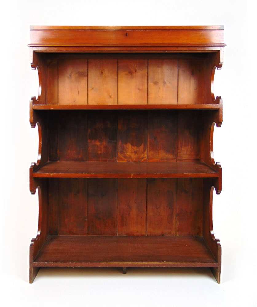 An early 20th century walnut open bookcase with display case to top, the case with glazed top over