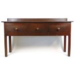 An early 20th century pine and beech sideboard/work bench, the top over three drawers on square