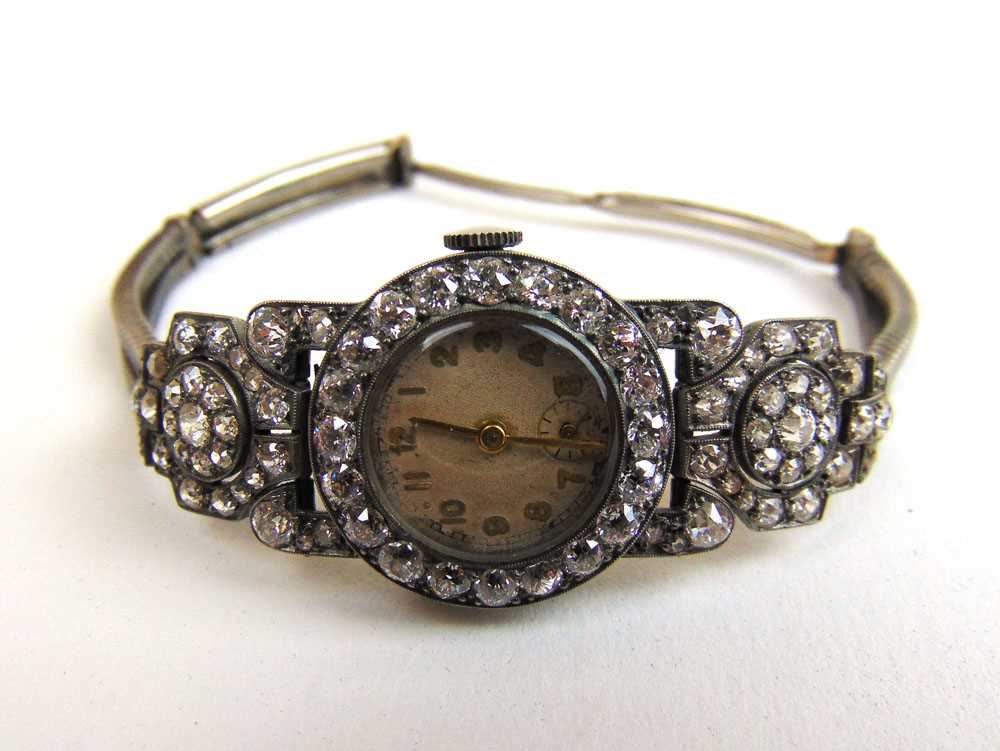 A mid 20th century lady's white metal and diamond set cocktail watch. Total diamond weight estimated