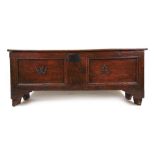 A late 17th/early 18th century elm six plank coffer/sword box, the top lifting to reveal a vacant