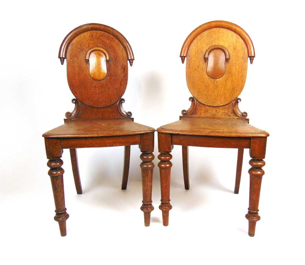 A pair of 19th century oak hall chairs, the oval back supported on carved C-scrolls on turned - Image 2 of 2