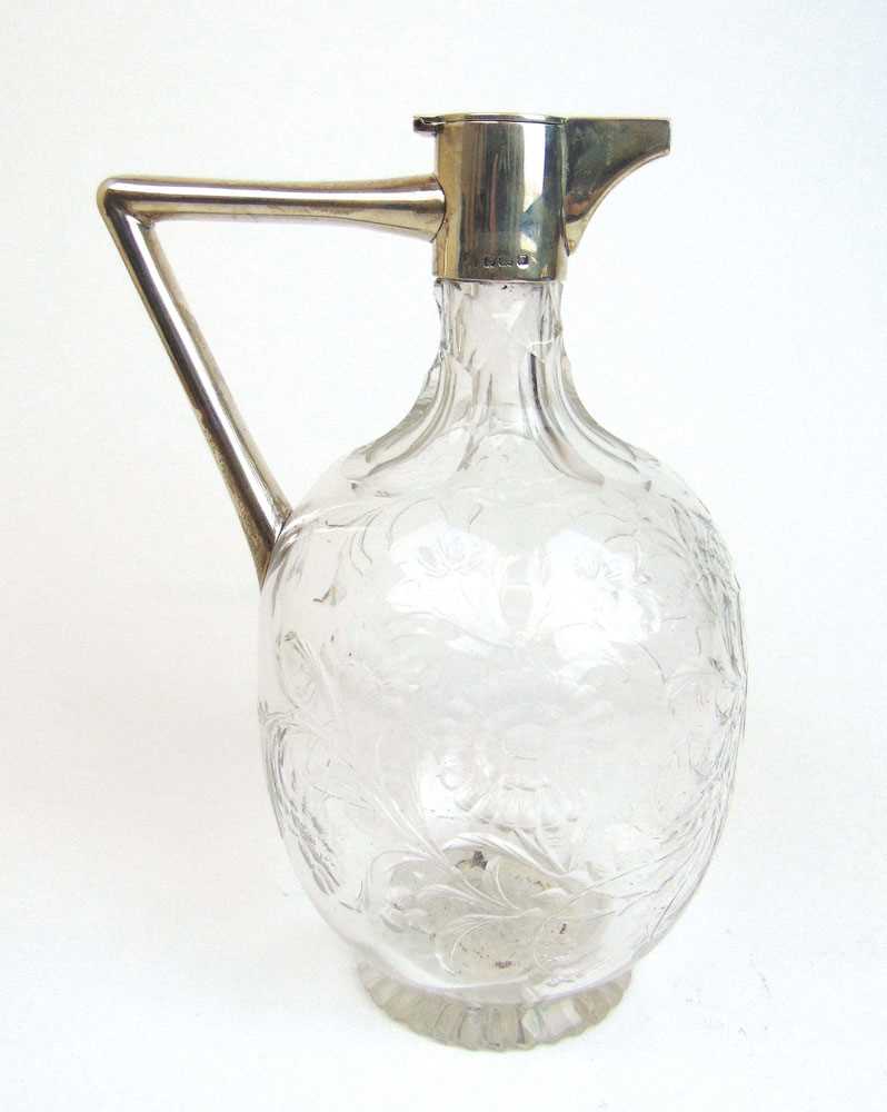 A George VI silver and cut glass claret jug, the body engraved with floral decoration. Hallmarked