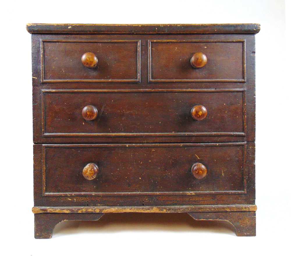 A 19th century scumbled pine chest, the lift up top revealing a vacant interior over the front