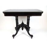 A late 19th century ebonized and parcel gilt card table, the fold over top on a swivel action over