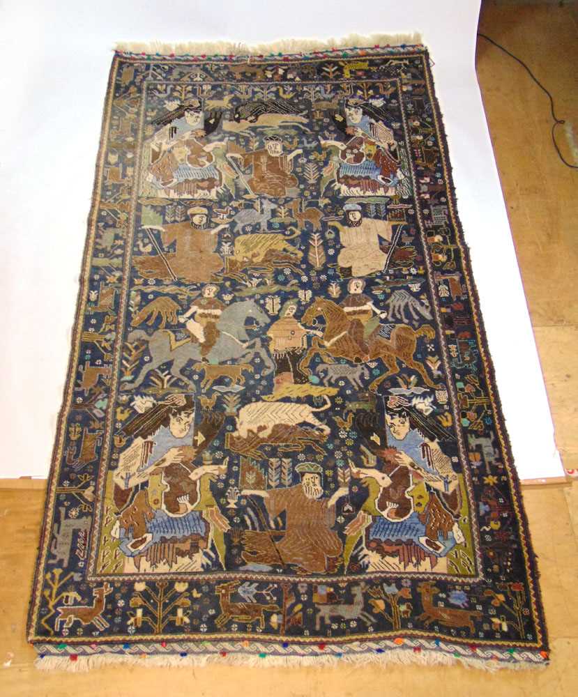 A handwoven Caucasian rug, the main border with animal motifs, surrounding the blue ground field