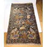 A handwoven Caucasian rug, the main border with animal motifs, surrounding the blue ground field