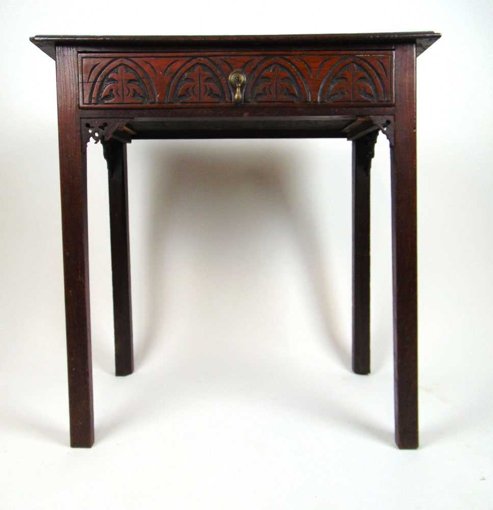 A 19th century oak single drawer side table, the moulded top over the carved drawer on chamfered