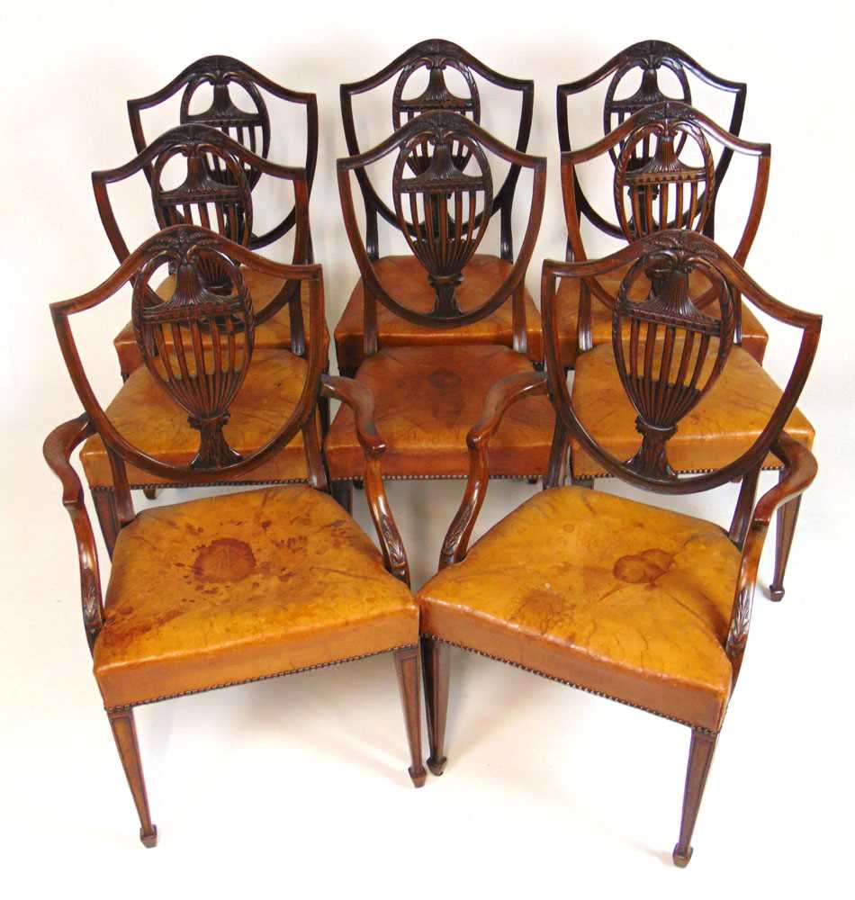 A set of eight early 20th century Hepplewhite style dining chairs upholstered in tan leather, the