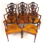 A set of eight early 20th century Hepplewhite style dining chairs upholstered in tan leather, the