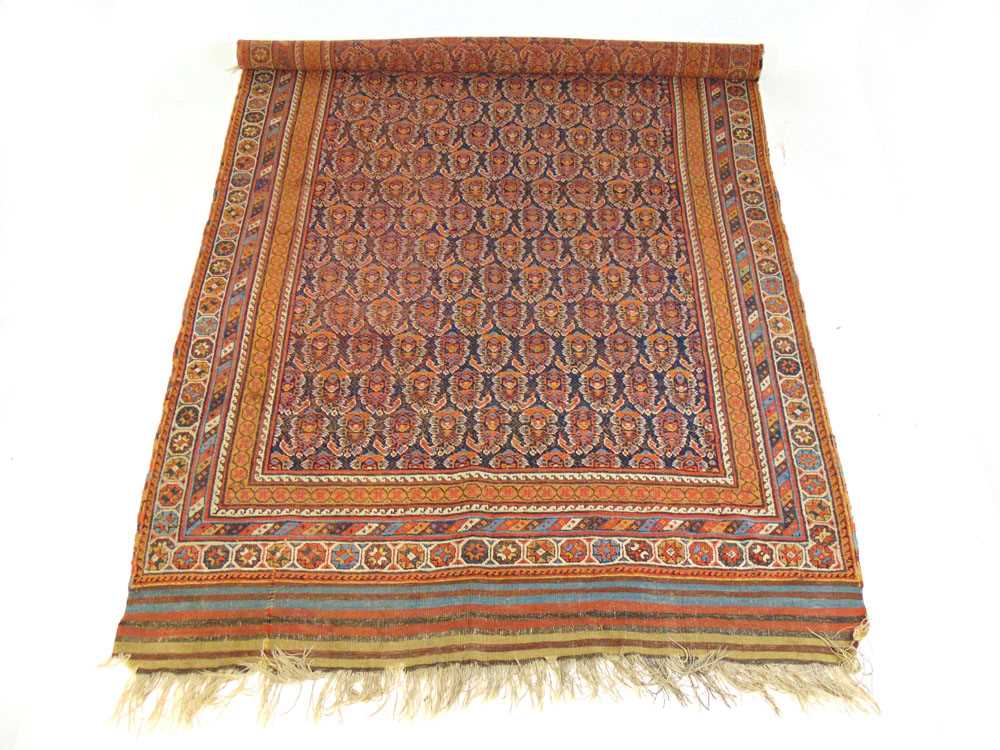 A handwoven Persian rug, possibly Kashan, the multi line border surrounding the blue ground field