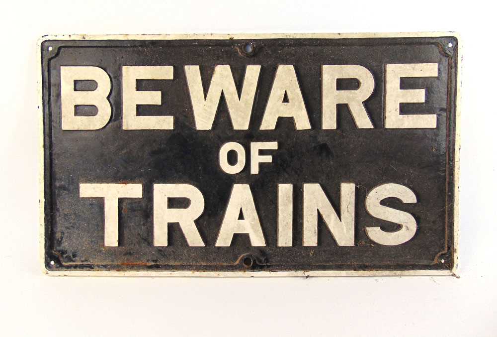 An early 20th century cast iron sign 'Beware of the Trains', h.49 cm, w.85 cm