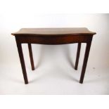 An 18th century and later mahogany and rosewood banded side table, the serpentine top on moulded