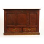 An 18th century and later oak mule chest, the moulded top over three field panel front and two