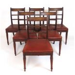 A set of six early 19th century mahogany dining chairs, the reeded back over a red leatherette
