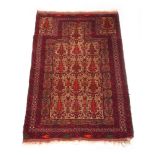 A handwoven Persian prayer rug, the multi line border surrounding the cream ground field with floral