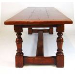An 18th century style oak 'refectory' table, the three plank cleated top on the base with turned