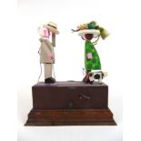 A Tony Mann (1927-2013) automaton modelled as a reverend greeting a lady as his dog cocks his