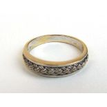 A yellow metal, rope twist design ring marked '18k'. Approx. weight 3.2g. Size O 1/2