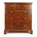 An 18th century oak and banded chest of two short over three graduating drawers with original