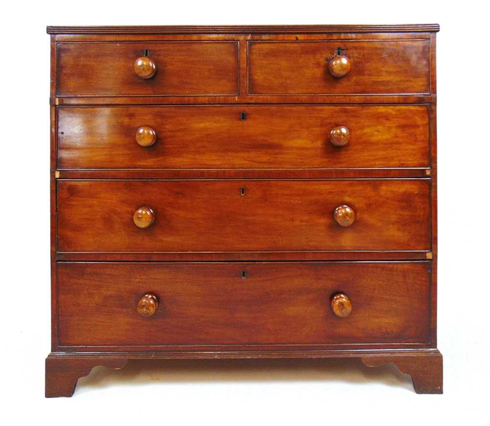 An early 19th century mahogany chest of two short over three graduating drawers on bracket feet,