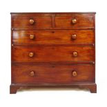 An early 19th century mahogany chest of two short over three graduating drawers on bracket feet,