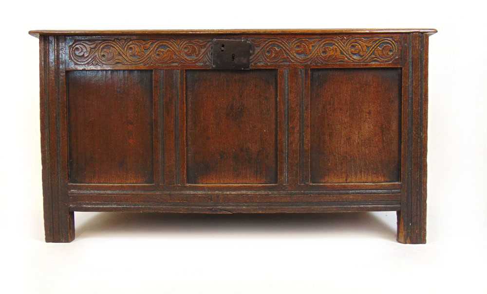 An early 18th century oak coffer, the top lifting to reveal a vacant interior over the three panel