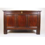 An early 18th century oak coffer, the three panel top lifting to reveal a vacant interior with