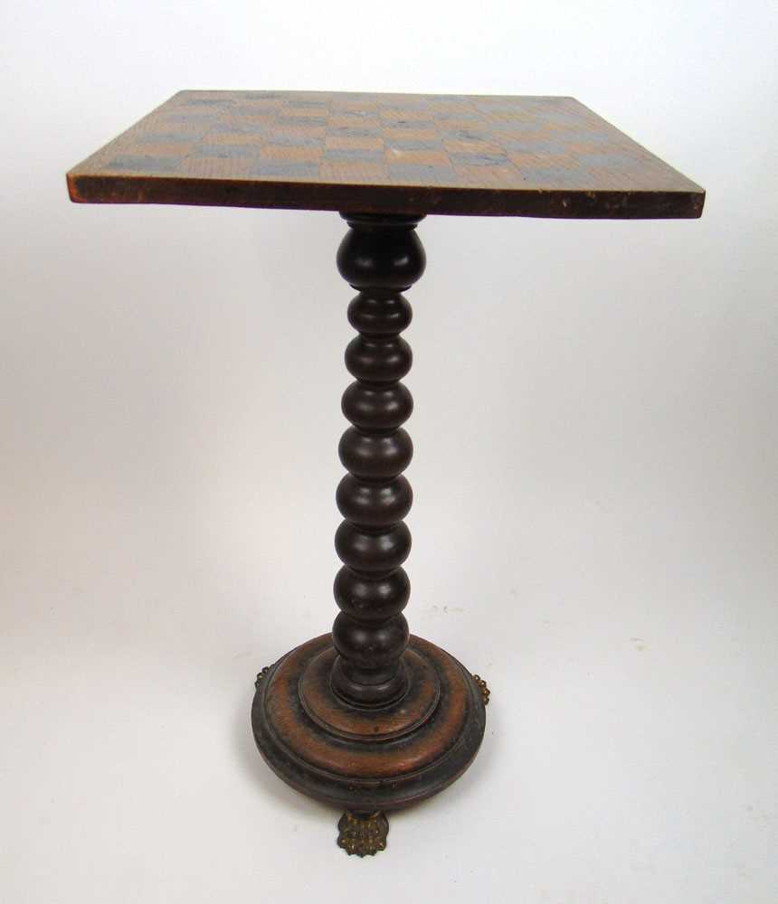 An early 19th century oak games table, the revolving top on a tapering bobbin column and circular - Image 2 of 3