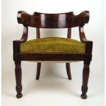 An early 19th century mahogany tub chair, the curved back supported on C-scrolls over the seat