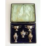 A five piece George V silver condiment set in presentation case. Hallmarked for Sheffield 1924,