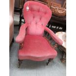A Victorian walnut nursing chair upholstered in a cut pink button back fabric, the arms on barley
