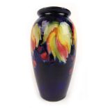 A Moorcroft vine and berry pattern vase on blue ground, h. 19.5 cmGlazing crazed. No other