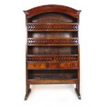 An 18th century oak and fruitwood possibly French bookcase/hunting rack, the dome top over