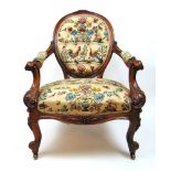 A 19th century rosewood nursing chair upholstered in a button back fabric with floral and animal