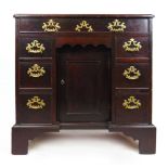 A mid 18th century mahogany kneehole desk, the moulded top with re-entrant corners above a single