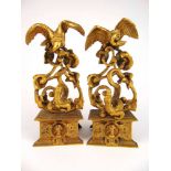 A pair of 19th century gilt metal clock garnitures modelled as crocodiles attacking vultures, h.