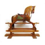 A Stevenson Brothers walnut rocking horse, forward looking head, horse hair mane and tail with